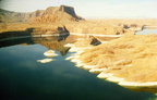 upper-reaches-of-lake-powell-contrasts-the-sandstone-rock-with-the-deep-green-waters-and-a-yellow-band-indicating-the-water-level-changes-behind-the-dam 6447601273 o